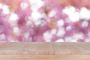 brown wood table top on bokeh abstract pink background - can be used for montage or display your products photo