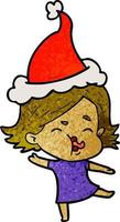 textured cartoon of a girl pulling face wearing santa hat vector