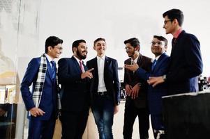 Group of six indian business man in suits standing on cafe and disscuss something. photo