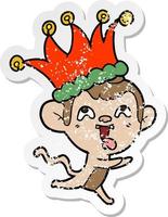 distressed sticker of a crazy cartoon monkey wearing jester hat vector