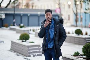 African man wear on jacket at cold winter weather posed outdoor. photo