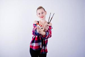 hermosa mujer artista pintora con pinceles posando en estudio aislado en blanco. foto