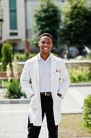 African american doctor male at lab coat with stethoscope outdoor. photo