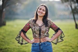 Pretty latino model girl from Ecuador wear on jeans posed at street. photo