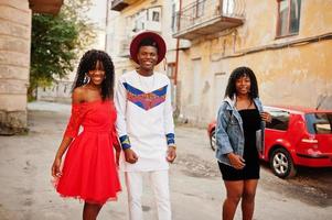 grupo de tres elegantes amigos de moda afro francia posaron en el día de otoño. modelo de hombre africano negro con dos mujeres de piel oscura. foto