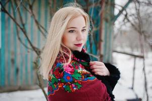 Blonde girl with hand embroidered scarf posed at winter day. Women's handkerchief. photo