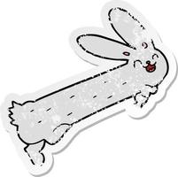 distressed sticker of a funny cartoon rabbit vector