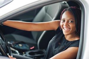 Portrait of young african american woman driving a car. photo