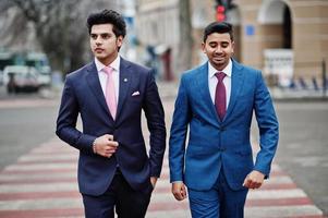 Two elegant indian fashionable mans model on suit walking at cross pedestrian. photo