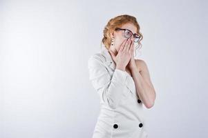 Curly hair girl astonished face in glasses isolated on white studio background. photo