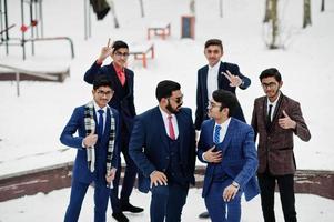 Group of six indian businessman in suits posed outdoor in winter day at Europe. photo