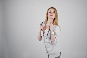 Blonde sexy doctor nurse with stethoscope isolated on white background. photo