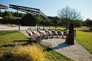 Fireplace with wooden chairs. Place for relax outdoor. photo