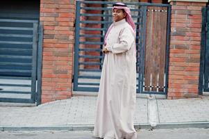 Middle Eastern arab man posed on street against modern building. photo