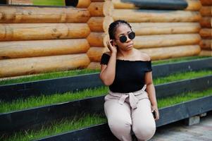 Stylish african american woman at sunglasses posed outdoor. photo