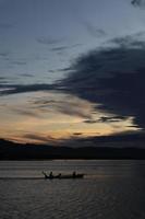 Fisherman on His Boat at Sunset. Fishermen Boat at Sunset photo