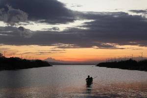 Fisherman on His Boat at Sunset. Fishermen Boat at Sunset photo