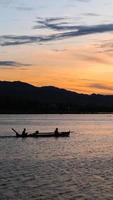 Fisherman on His Boat at Sunset. Fishermen Boat at Sunset photo