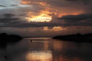 Fisherman on His Boat at Sunset. Fishermen Boat at Sunset photo