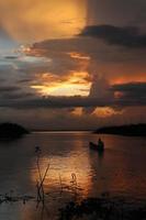 Fisherman on His Boat at Sunset. Fishermen Boat at Sunset photo