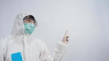 Doctor in PPE suit gesture make hand sign. Represent victory win over virus. photo