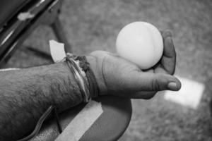 Blood donor at Blood donation camp held with a bouncy ball holding in hand at Balaji Temple, Vivek Vihar, Delhi, India, Image for World blood donor day on June 14 every year, Blood Donation Camp photo