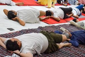 New Delhi, India, June 19 2022 -Group Yoga exercise session for people of different age groups in Balaji Temple, Vivek Vihar, International Yoga Day, Big group of adults attending yoga class in temple photo