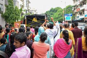 New Delhi, India July 01 2022 - A huge gathering of devotees from different parts of Delhi on the occasion of ratha yatra or rathyatra. Rath for Lord Jagannath pulled by people, Jagannath Rath Yatra photo