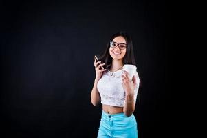 Portrait of a young happy woman in white top and blue trousers with a cup of coffee in her hand. photo