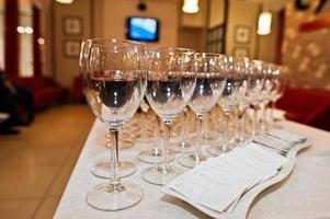 Different alcohol beverages in glasses on the table in restaurant or bar. photo