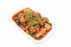 Spicy seafood fried served on white dish photo