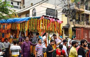 New Delhi, India July 01 2022 - A huge gathering of devotees from different parts of Delhi on the occasion of ratha yatra or rathyatra. Rath for Lord Jagannath pulled by people, Jagannath Rath Yatra photo