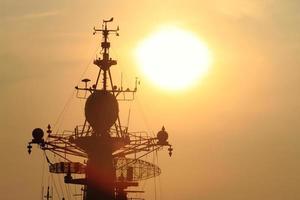 battleship with sunset behind photo
