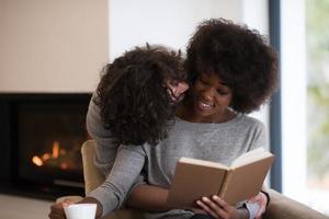 multiethnic couple hugging in front of fireplace photo