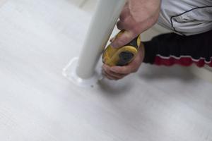 repairman working with drilling machine photo