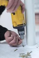 repairman working with drilling machine photo