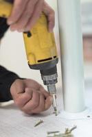 repairman working with drilling machine photo