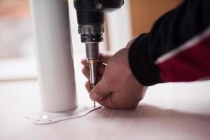 repairman working with drilling machine photo