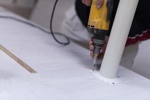 repairman working with drilling machine photo