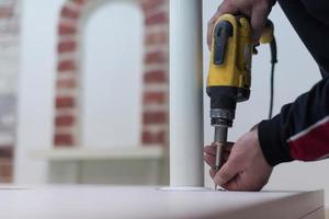repairman working with drilling machine photo