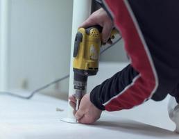 repairman working with drilling machine photo