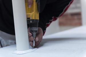 repairman working with drilling machine photo