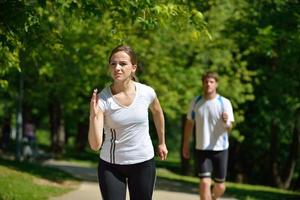 Young couple jogging at morning photo