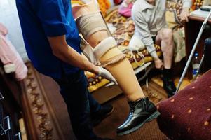 The prosthetist removes the measure from a person with a disability, man with amputee. photo