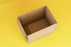 Empty open cardboard boxes on yellow background photo