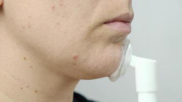 woman applying foam to her face to cleanse the skin video