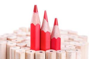 three sharpened red pencil among many ones photo