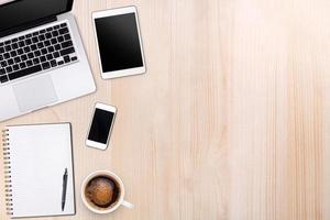 Top view laptop computer or notebook,mobile phone and cup of latte art coffee on wooden table. Business template mock up for adding your text. photo