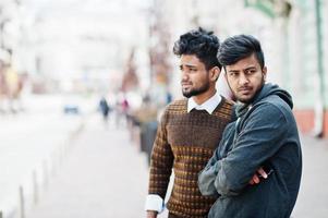 Two young stylish indian man frieds model posing in street. photo