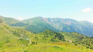 Aerial fly over solo woman hiker with backpack stand on viewpoint in scenic green valley in remote caucasus, Adjara region video